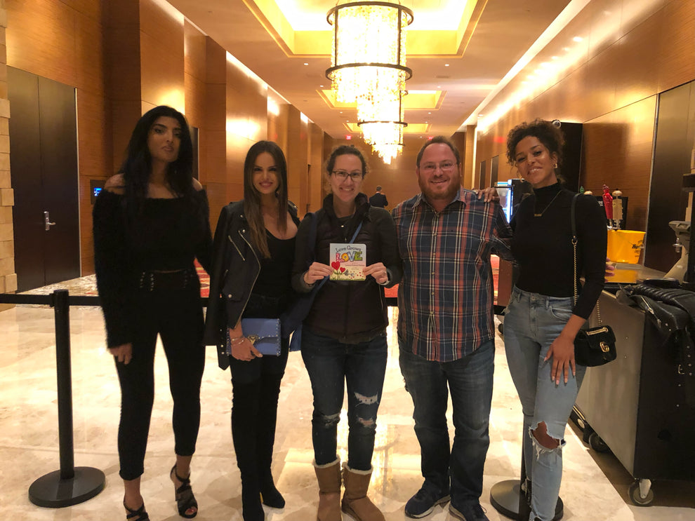 Lauren Grabois Fischer shares her book 'Love Grows Love' with Deal or No Deal Models, promoting kindness and positivity