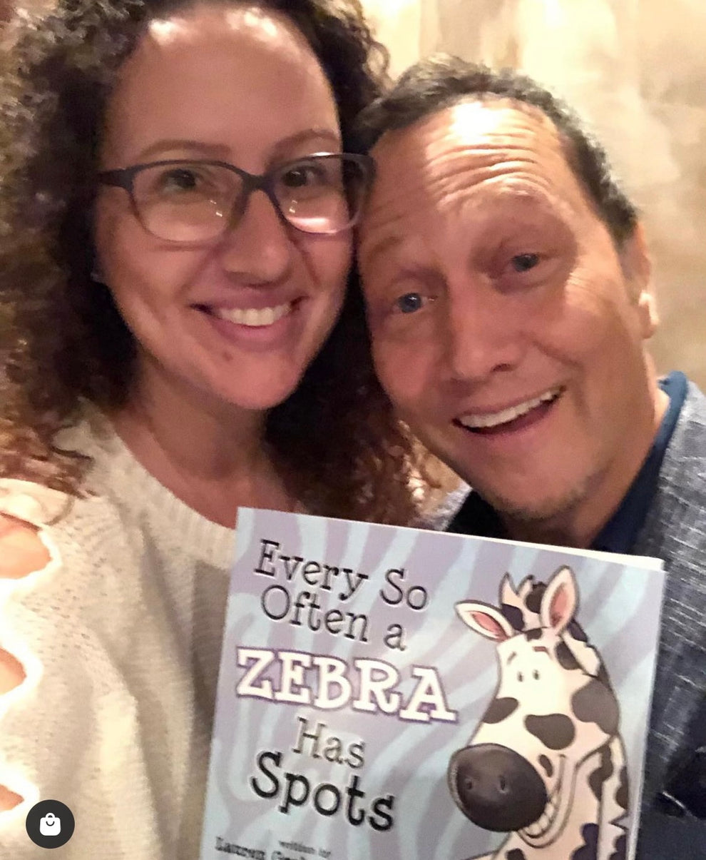 Lauren Grabois Fischer with Rob Schneider celebrating her children's book 'Every So Often a Zebra Has Spots' at a special event.