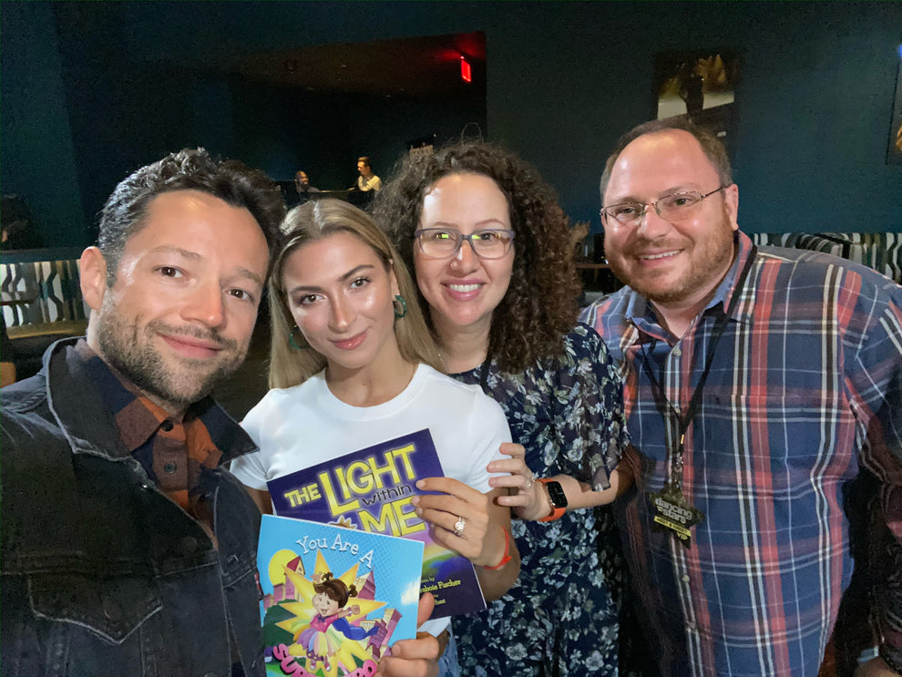 Lauren Grabois Fischer with Dancing With The Stars, Daniella Karagach and Pasha Pashkov holding 'The Light Within Me' and 'You Are A Superhero'